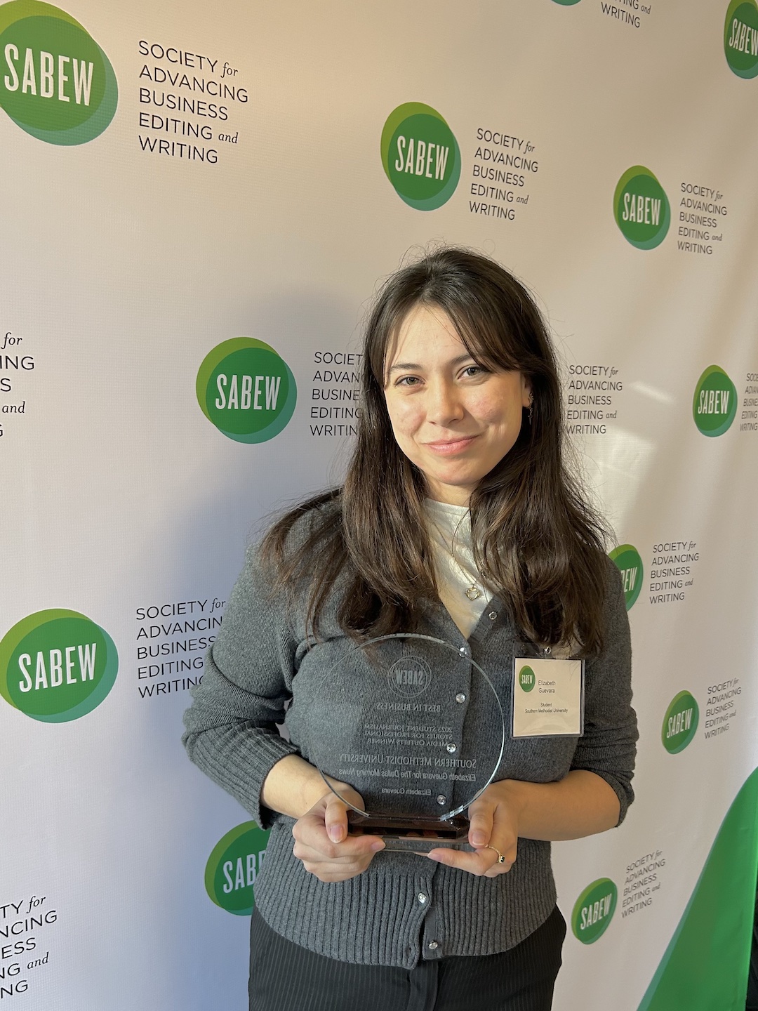 Senior Elizabeth Guevara poses with her award for student business reporting at the Society for Advancing Business Editing and Writing conference.
