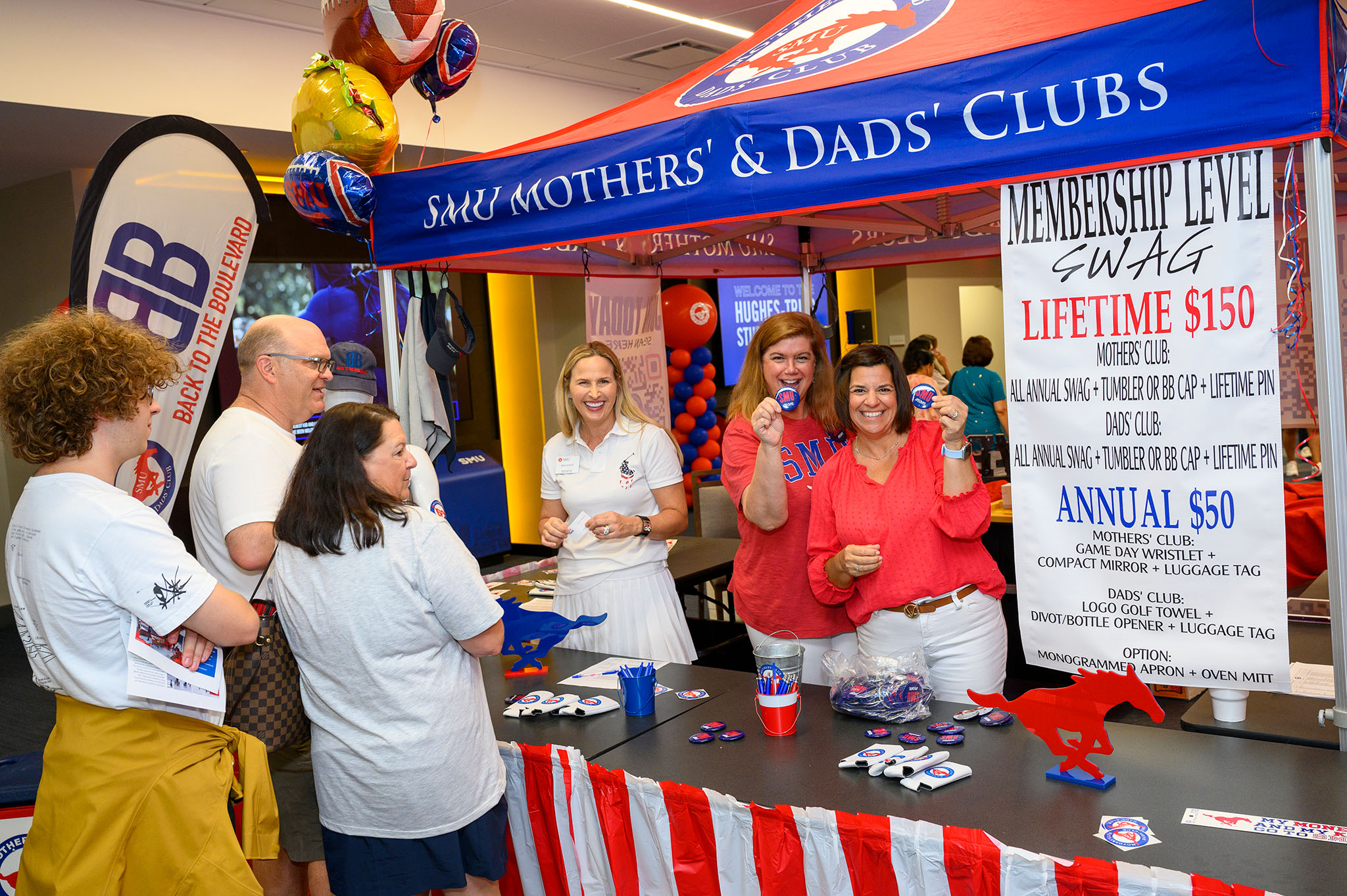 mothers' and dads' club tent with parents and students