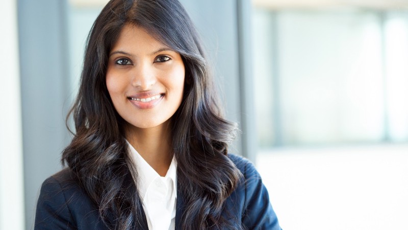 A headshot of a female online MBA student in a business suit