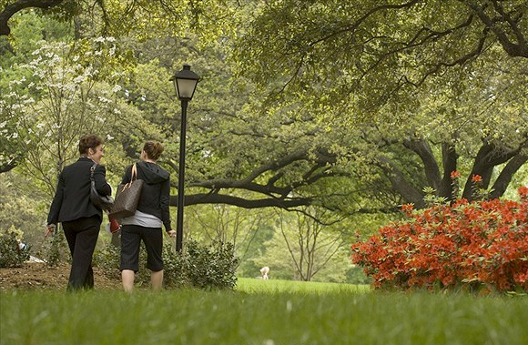 student and faculty walking on campus