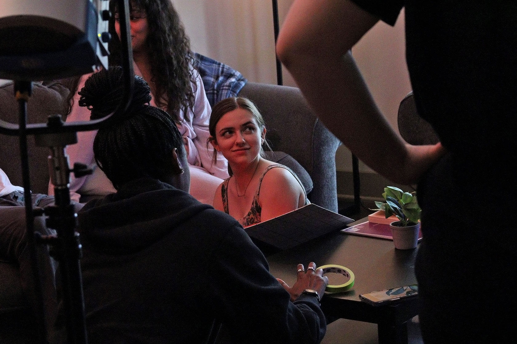 Director Piper Peña Hadley converses with crew members and actors on set.