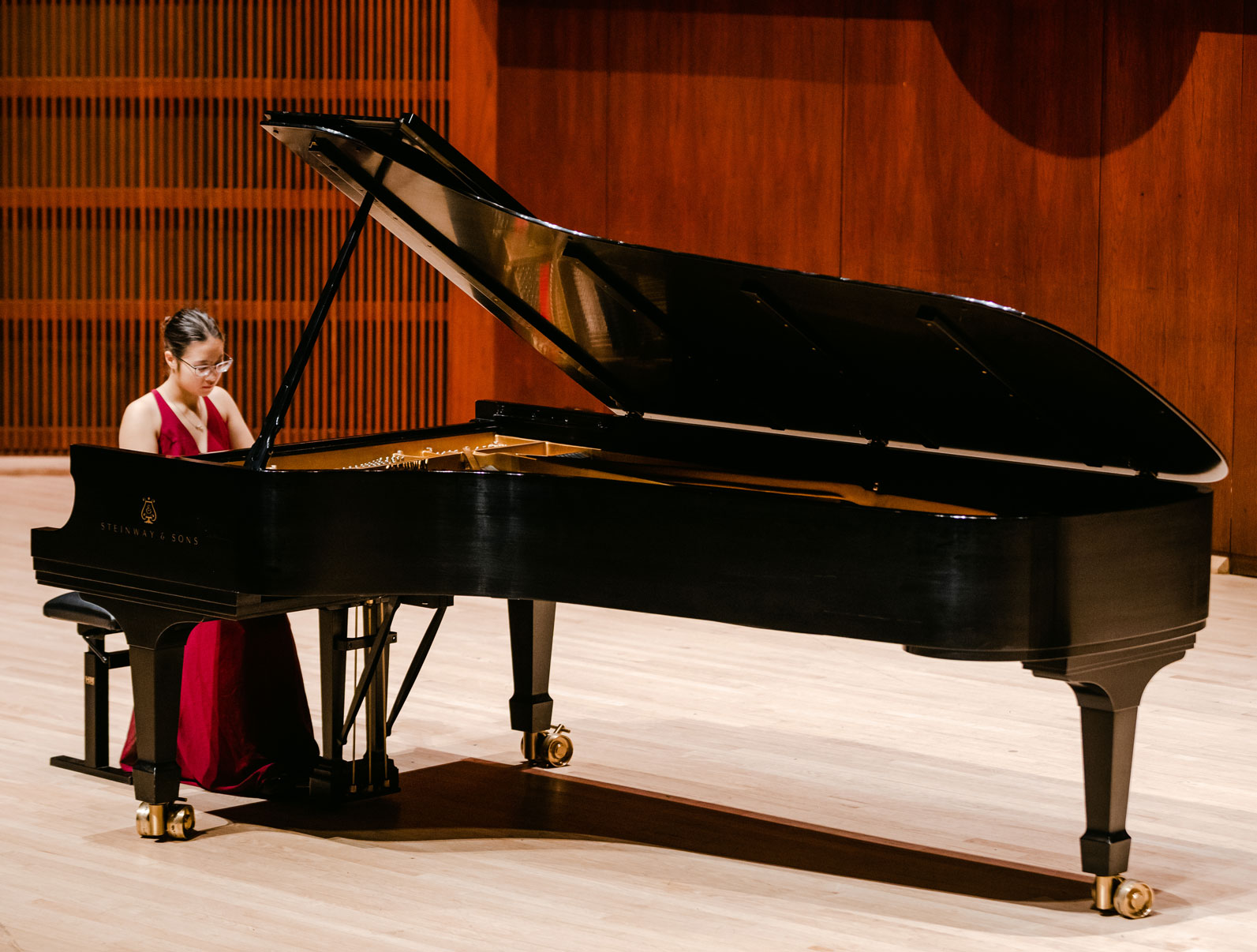Piano and math double major Yumi Hastings performs a piano composition piece on stage.