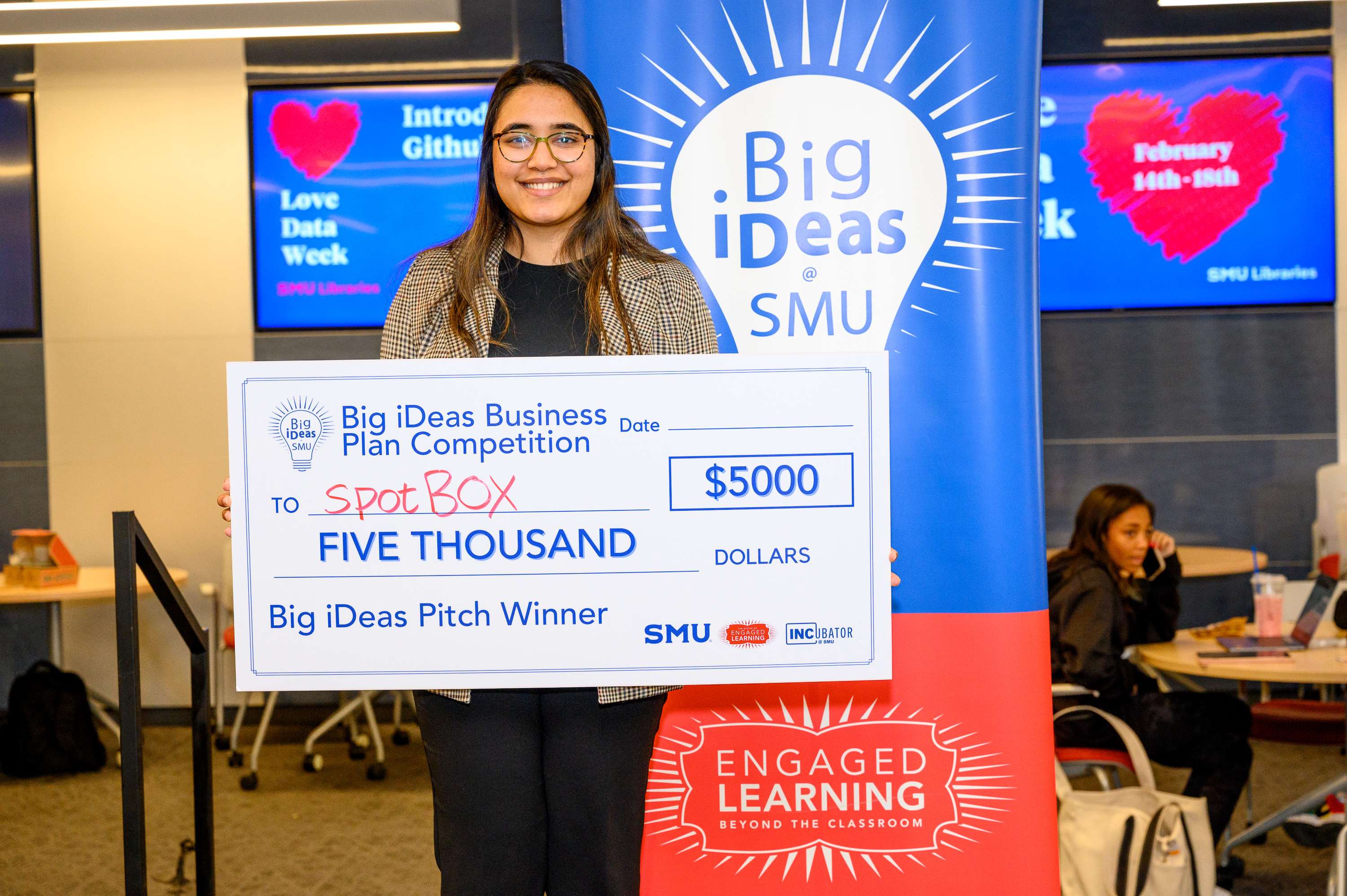Sonia Saeed, founder of spotBOX, with her big check at the Big iDeas competition