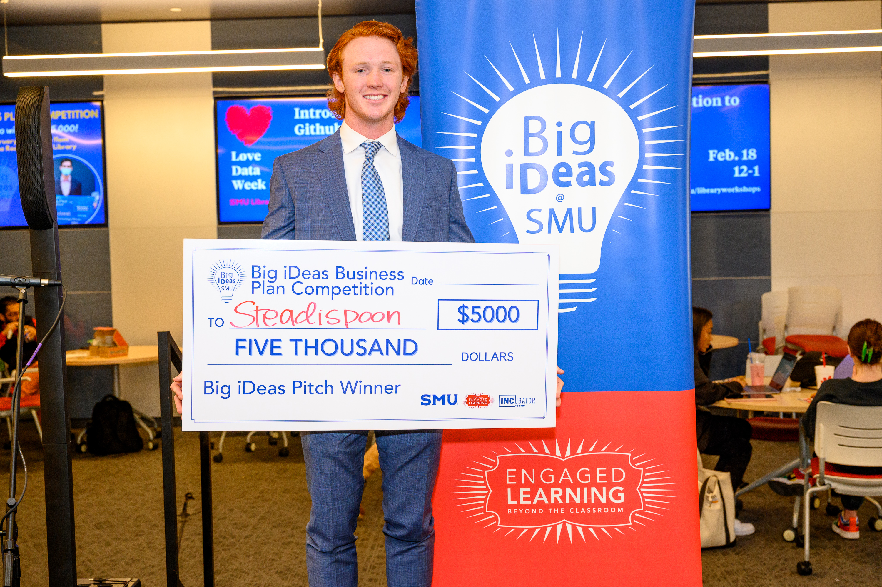 SteadiSpoon co-founder Mason Morland with his big check at the Big iDeas competition