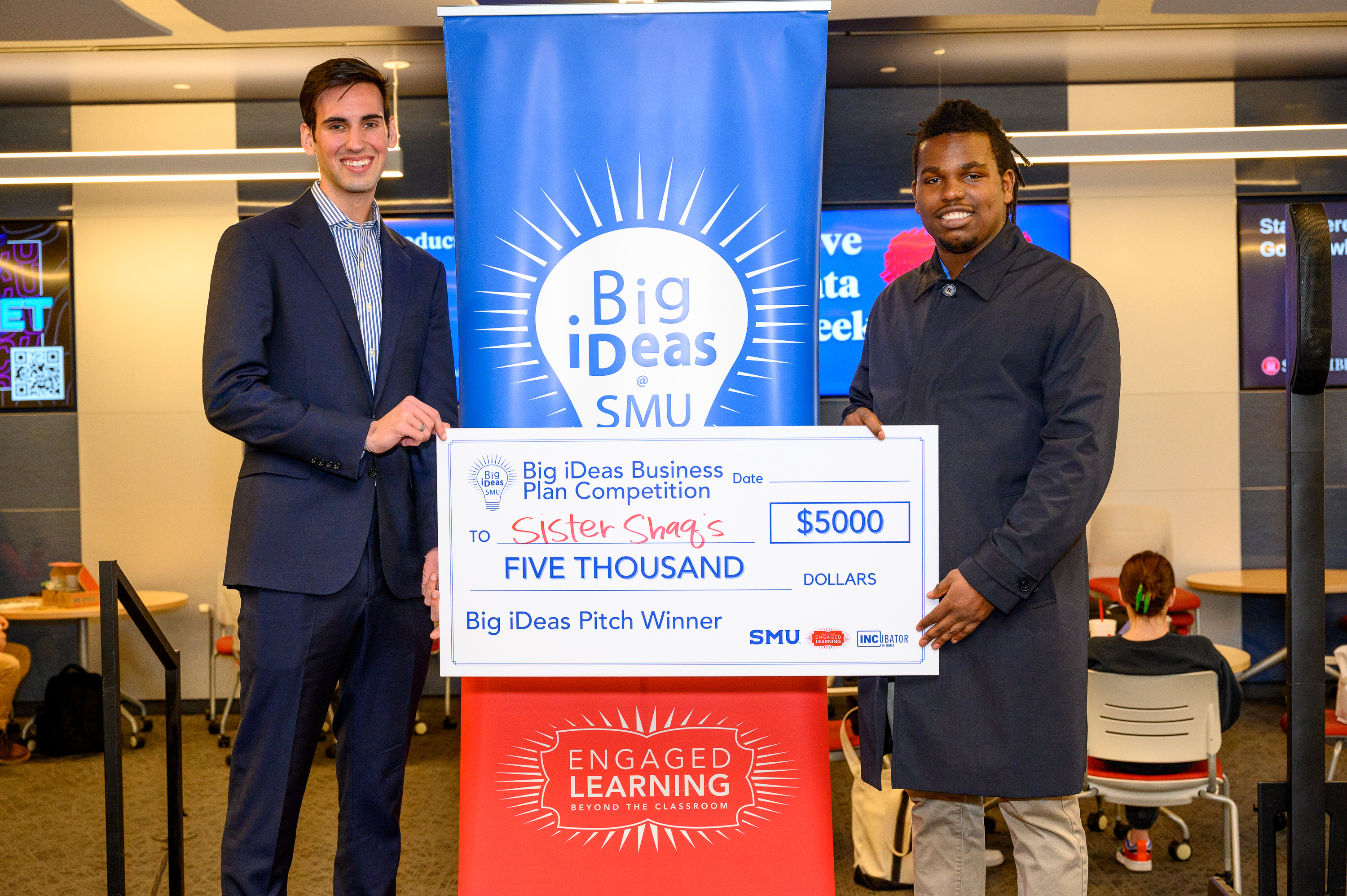 Sister Shaq's founders Raleigh Dewan with his big check at the Big iDeas competition