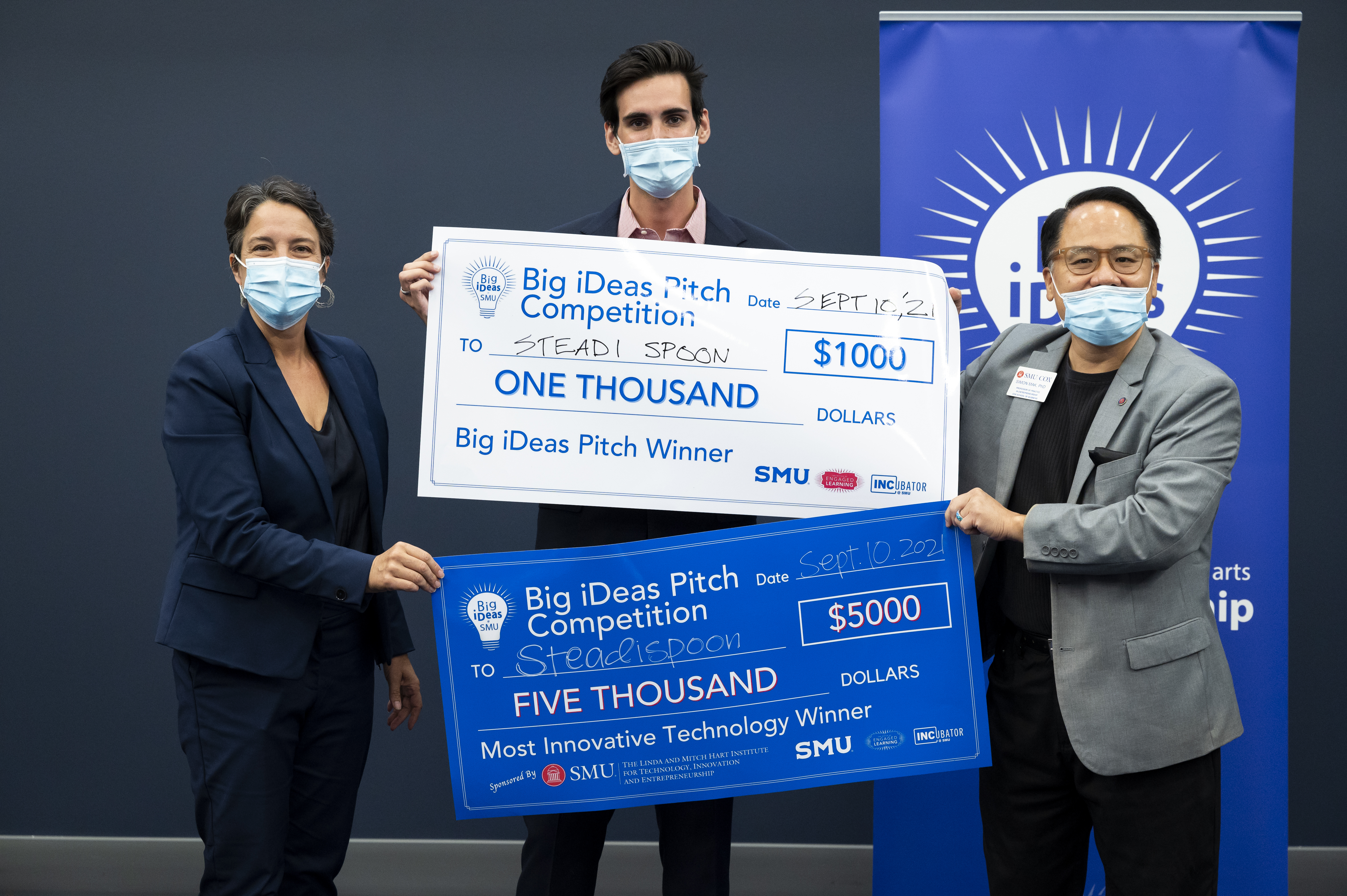 Picture of Raleigh Dewan (center) with his big check. Jennifer Ebinger (left) and Simon Mak (right)