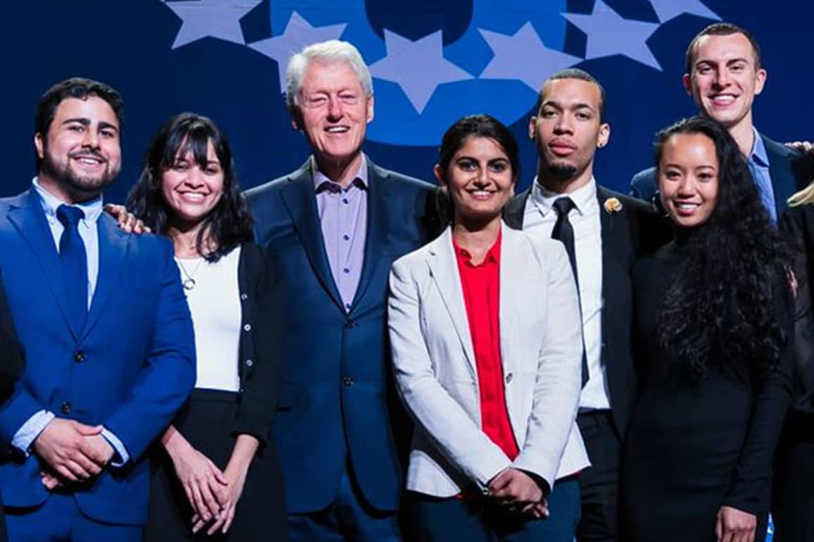 image of President Bill Clinton and student participants in the Clinton Global Initiative University