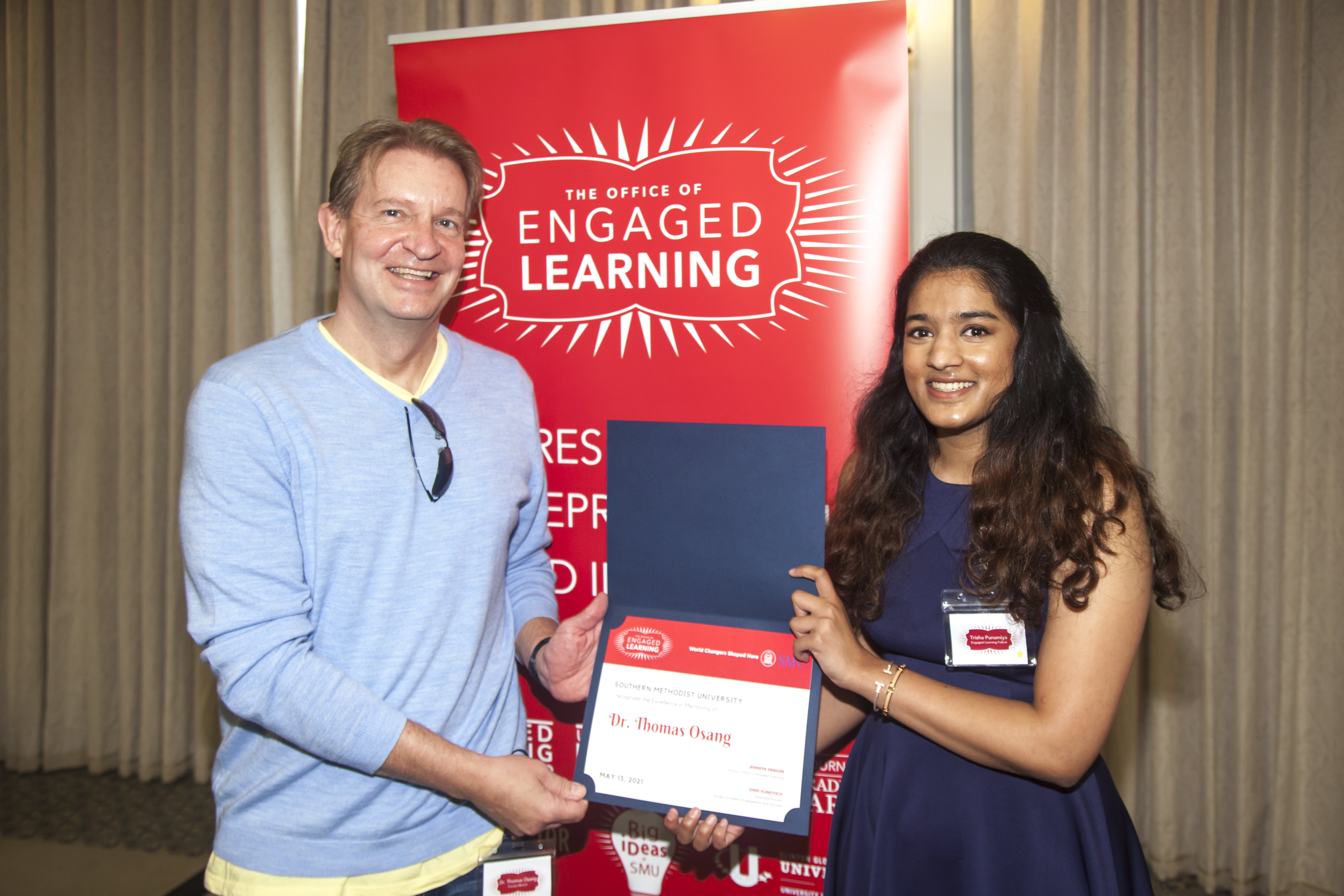 Professor Thomas Osang, left, with mentee Trisha Punayima, right. Showing his excellence in mentoring award at the Engaged Learning luncheon.