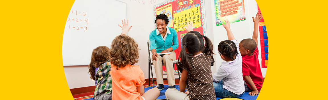 A teacher instructs children in a classroom.