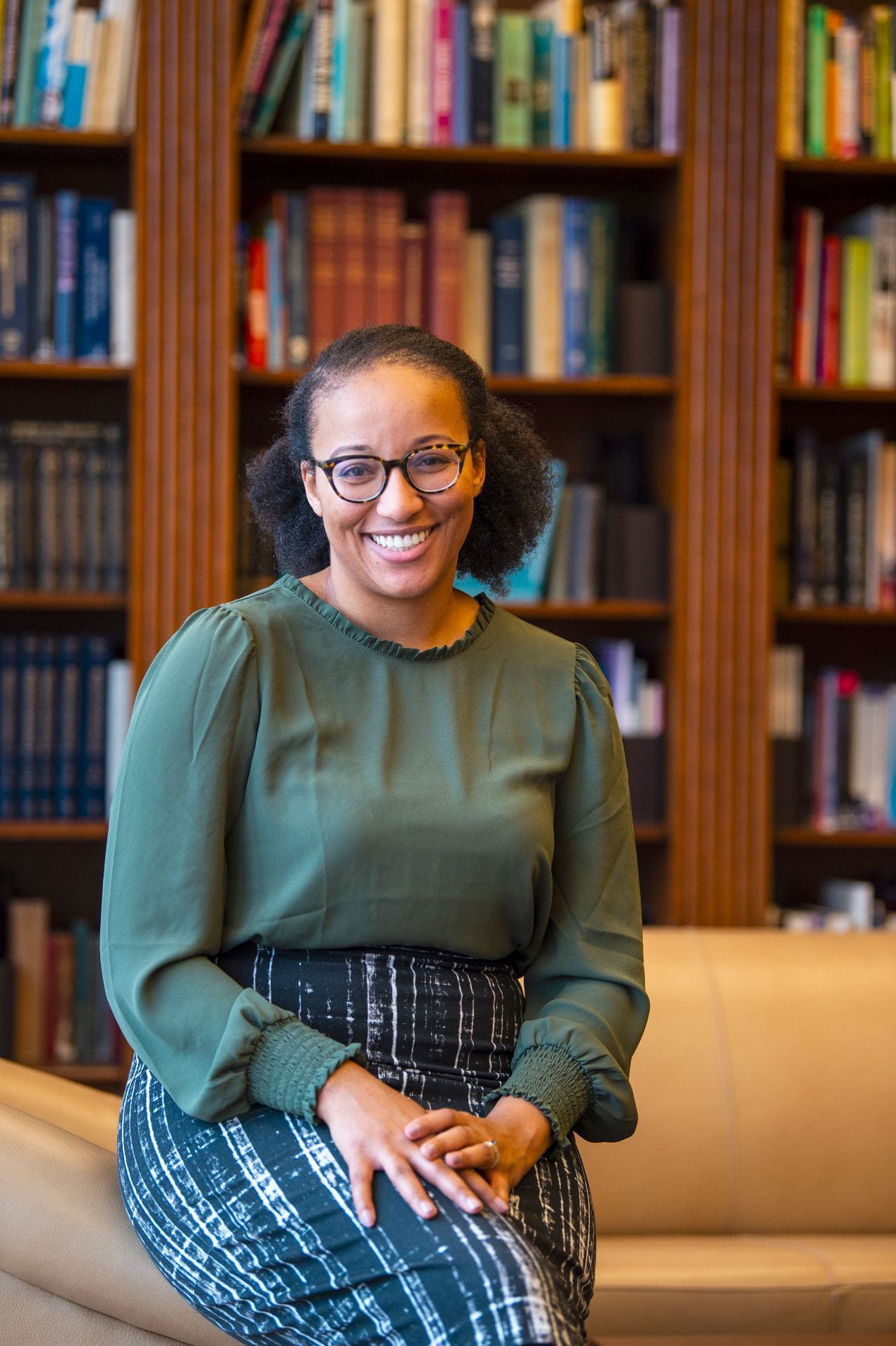 Dr. Dominique Baker smiles in the Annette Caldwell Simmons Hall Reading Room.