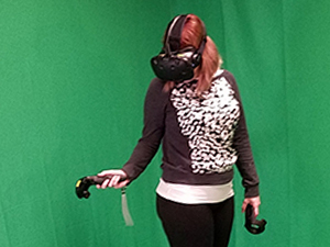 A woman immersed in a virtual reality experience, donning a headset and grasping a hand controllers.