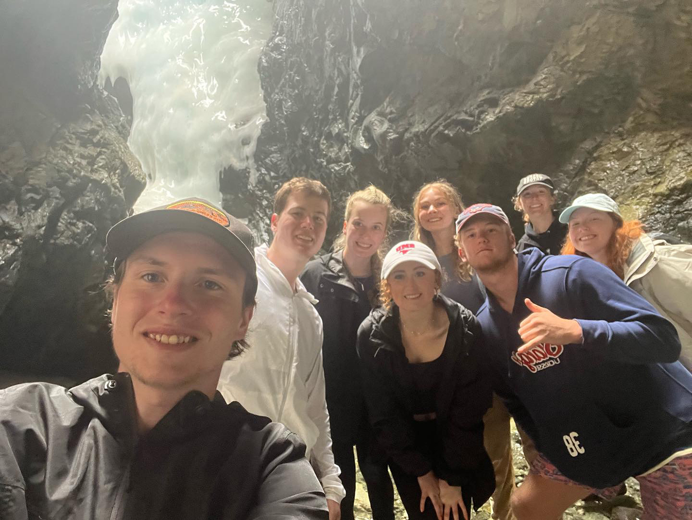 SMU-in-Taos students gather near a frozen waterfall