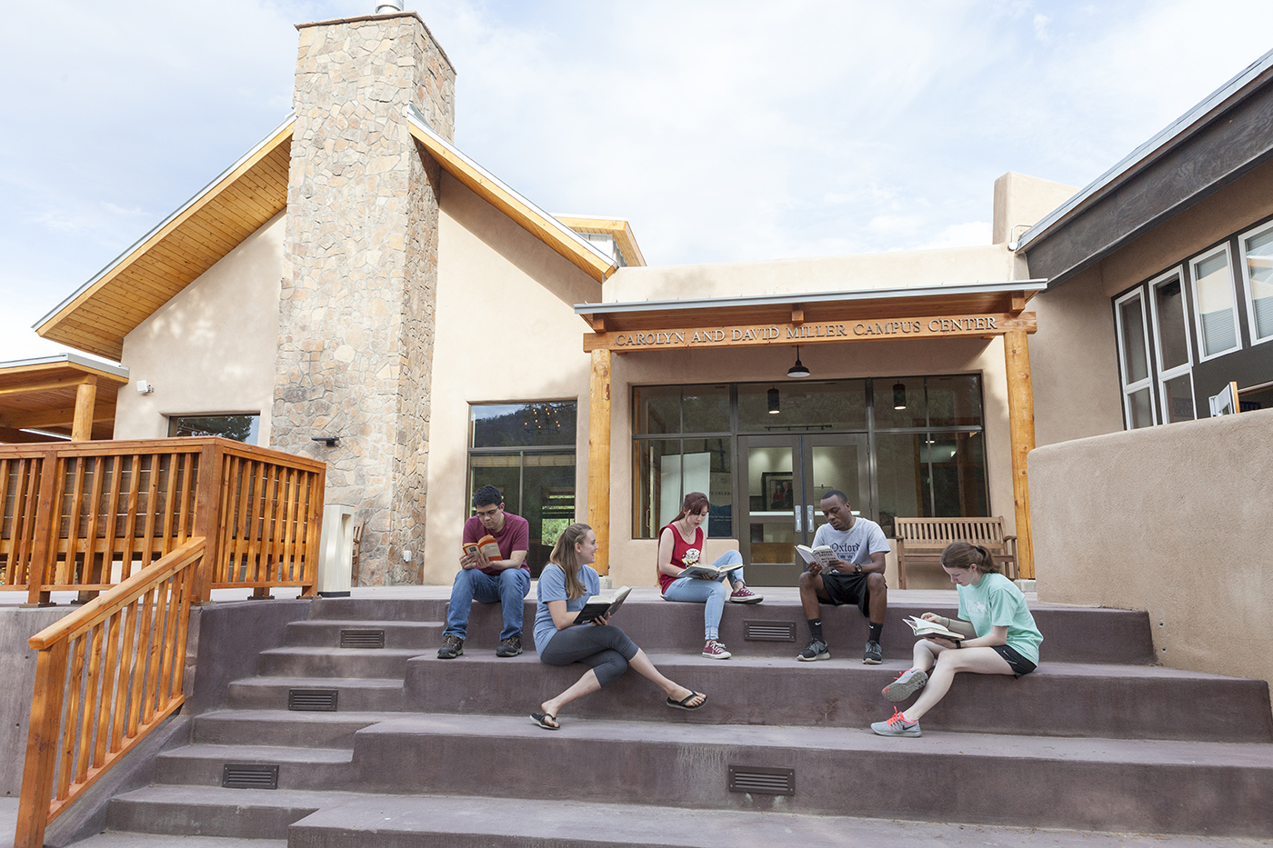Students study on the steps of the Miller Center at SMU-in-Taos.