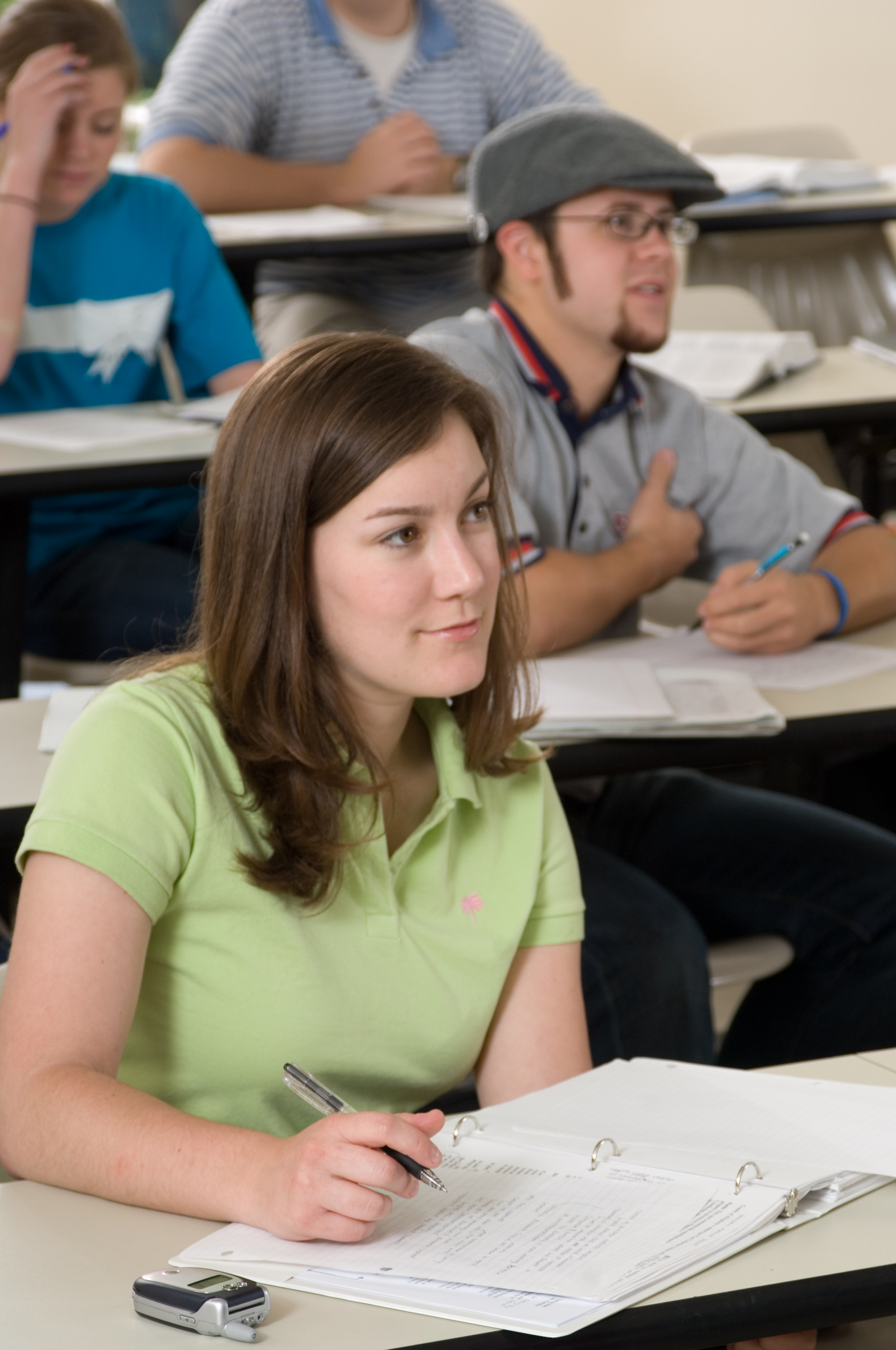 Student taking notes in a classroom