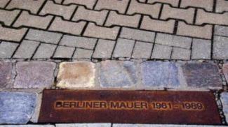 A double row of cobblestones marks the former location of the Berlin Wall.