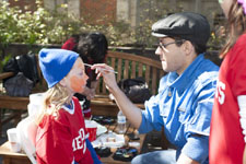 A face-painter at work in Peruna's Playground, SMU Homecoming 2012