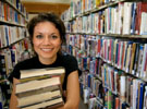 Student in the stacks at the library