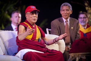 The Dalai Lama wearing an SMU baseball cap.