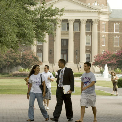Students and professor walking across the Southern Methodist University campus
