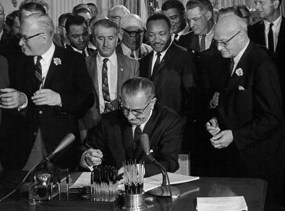 President Lyndon Johnson signs the Civil Rights Act of 1964