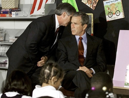 Andrew Card tells President George W. Bush about the 9/11 attack.
