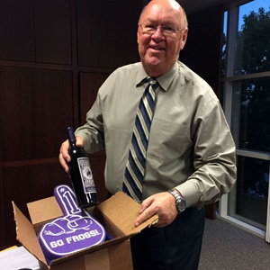 Dean Erekson sent Dean Myers a bottle of Purple Cowboy wine, in honor of “Cowtown’s” Horned Frogs—which, of course, wear purple and white—along with a logoed polo shirt, coffee mug and a foam “Frog” finger.