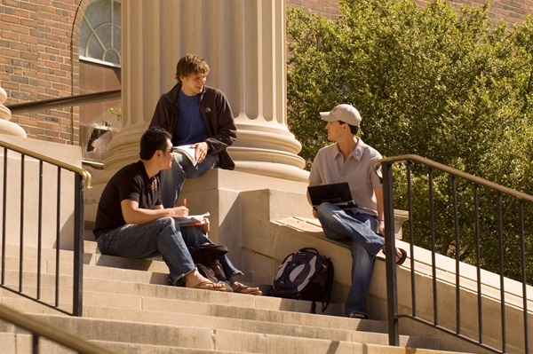 Students sitting on the steps of Dallas Hall