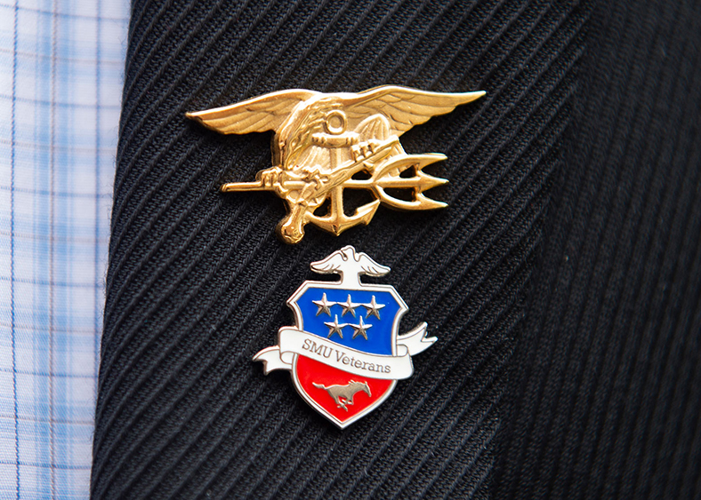 two military service pins pinned to a coat