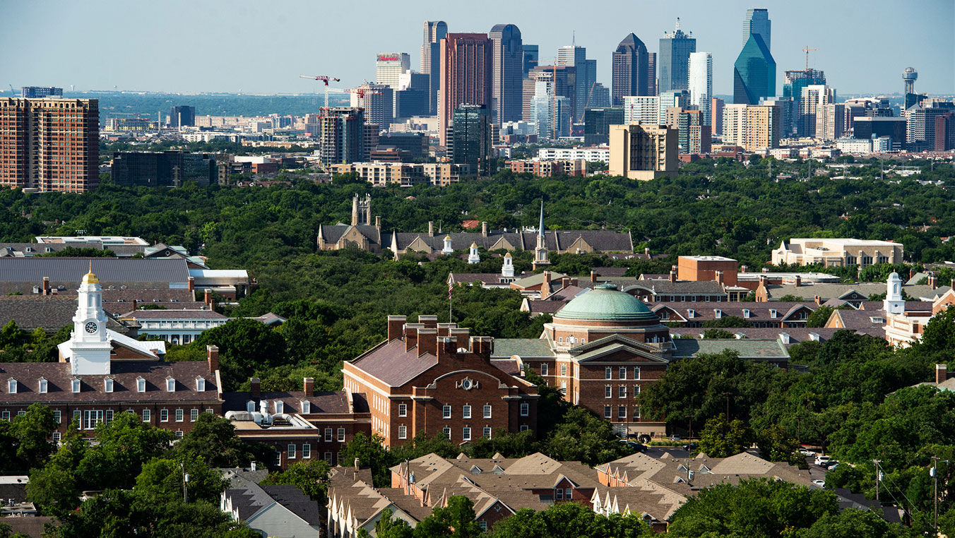 A photo of SMU's campus with the Dallas skyline in the background.