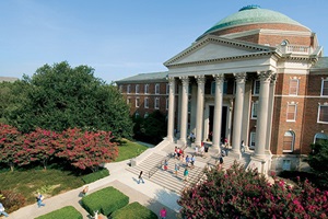 SMU's Dallas Hall has students on the stairs on a blue-skied day.