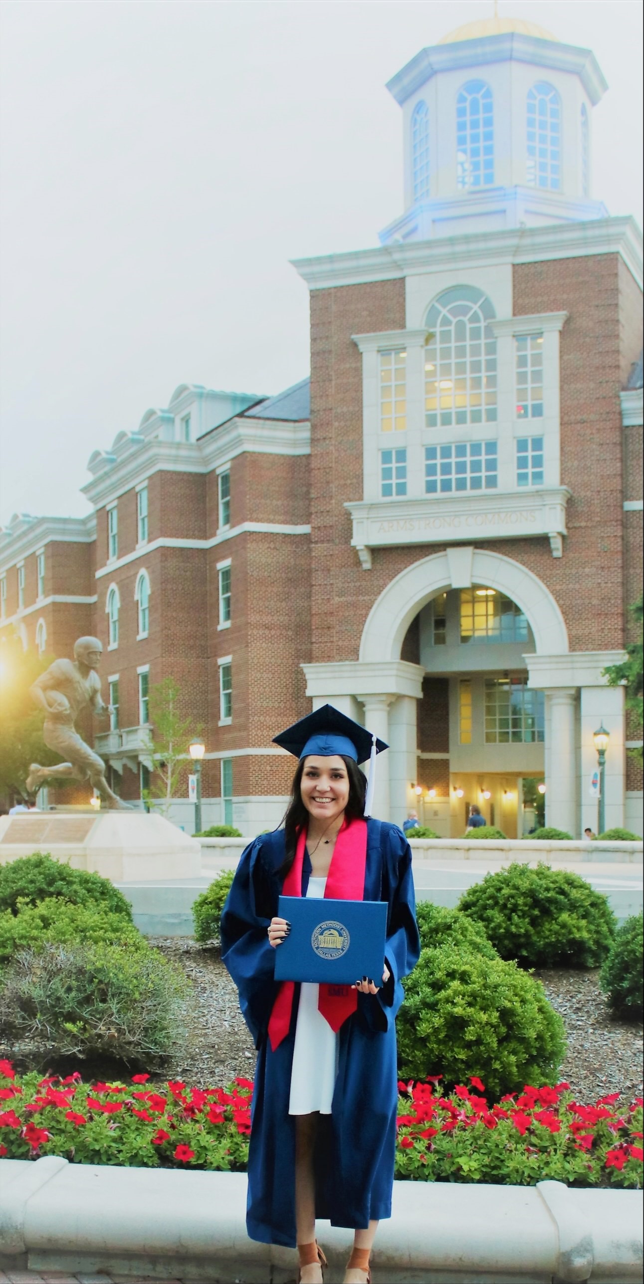 Briana Morales ’21, ’24 in front of building