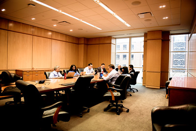 Photo of people around a table, strategizing at SMU Cox
