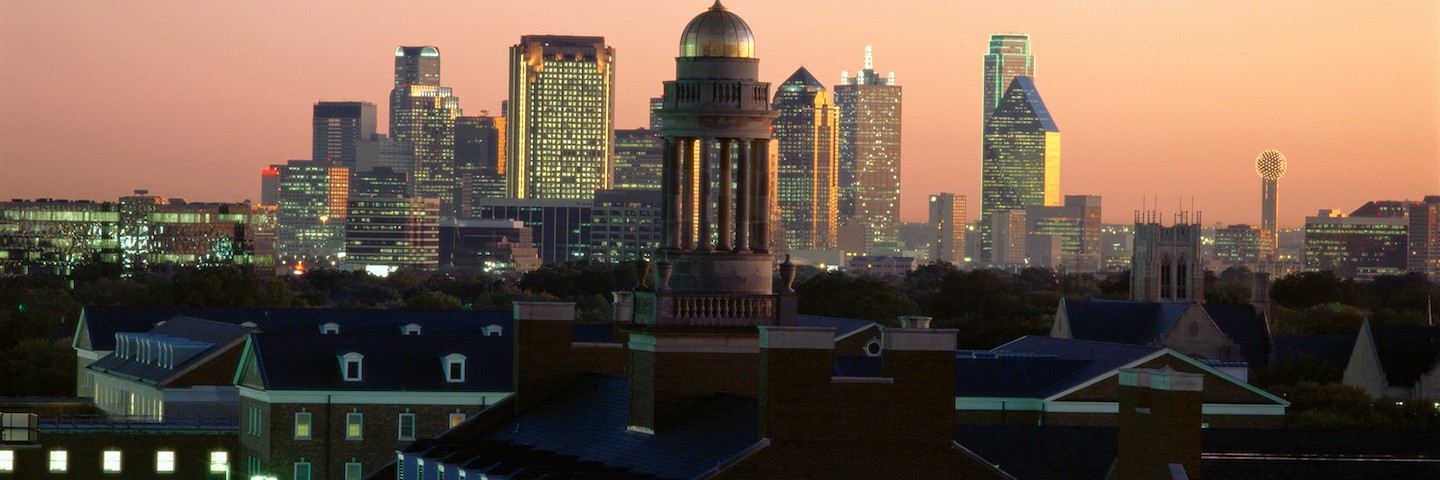 Downtown Dallas with Cox building in foreground during sunset