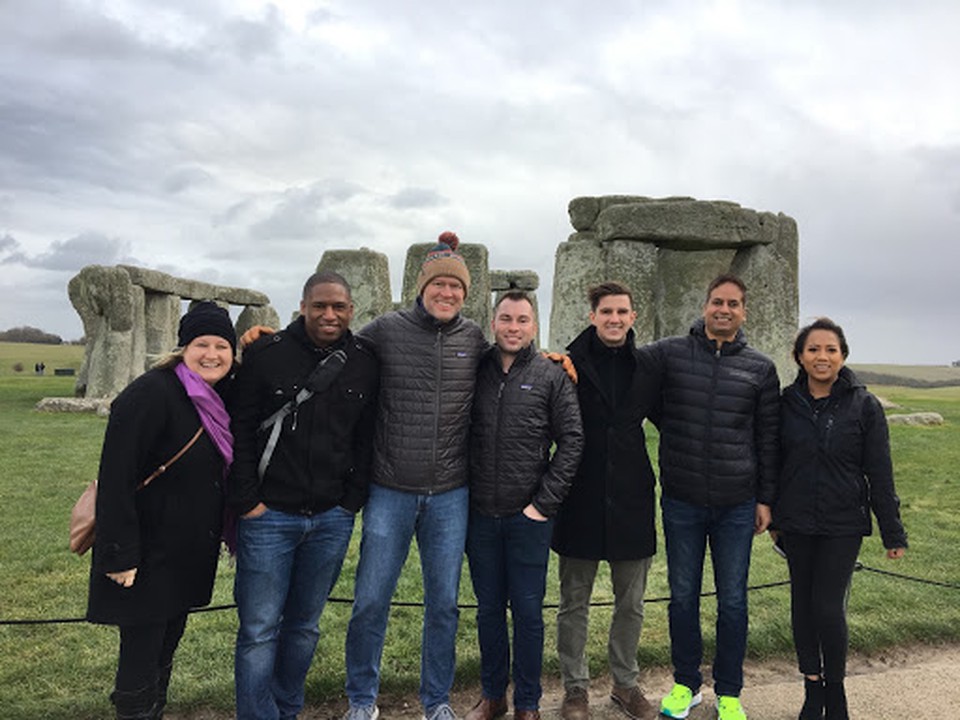 A group of SMU Cox MBA students pose outside in front of Stonehenge