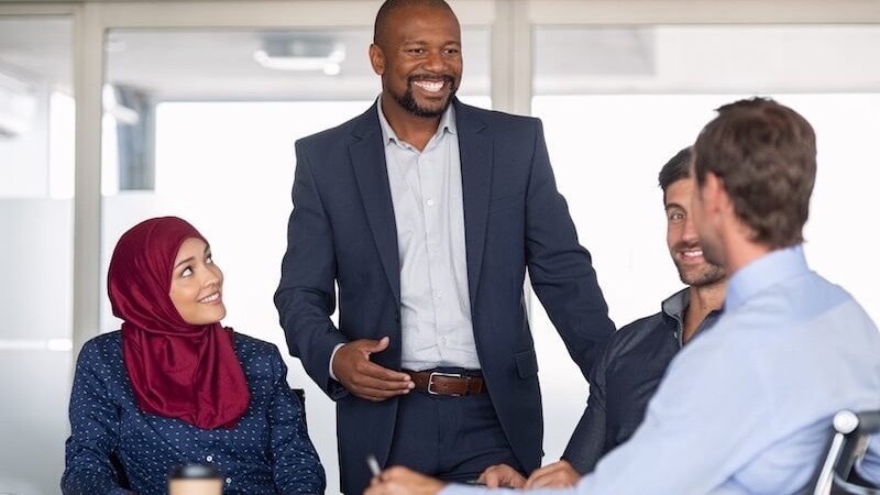 A group of business people engage in a cross-cultural business negotiation