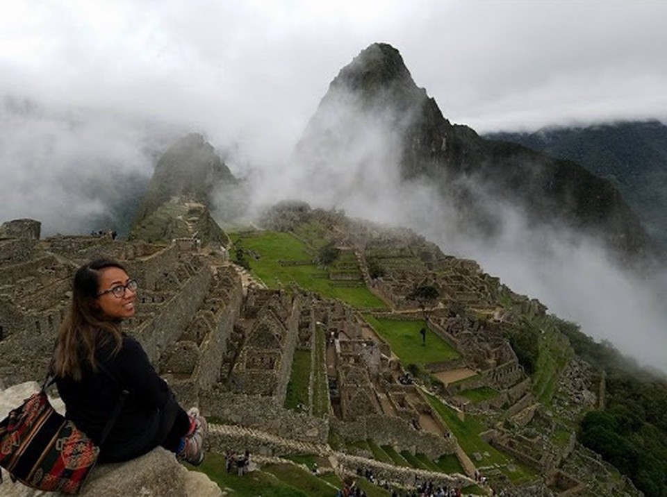 Kim travels and poses at Machu Picchu