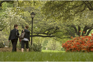 student and faculty walking on campus