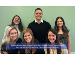 M.S. Organizational Psychology students stand in front of a green wall. Front row left to right: Elizabeth Kelley, Mary Winston Reames, Alyssa Randall. Back row left to right: Fer Reyna, Oscar Guevara, Hannah Smith