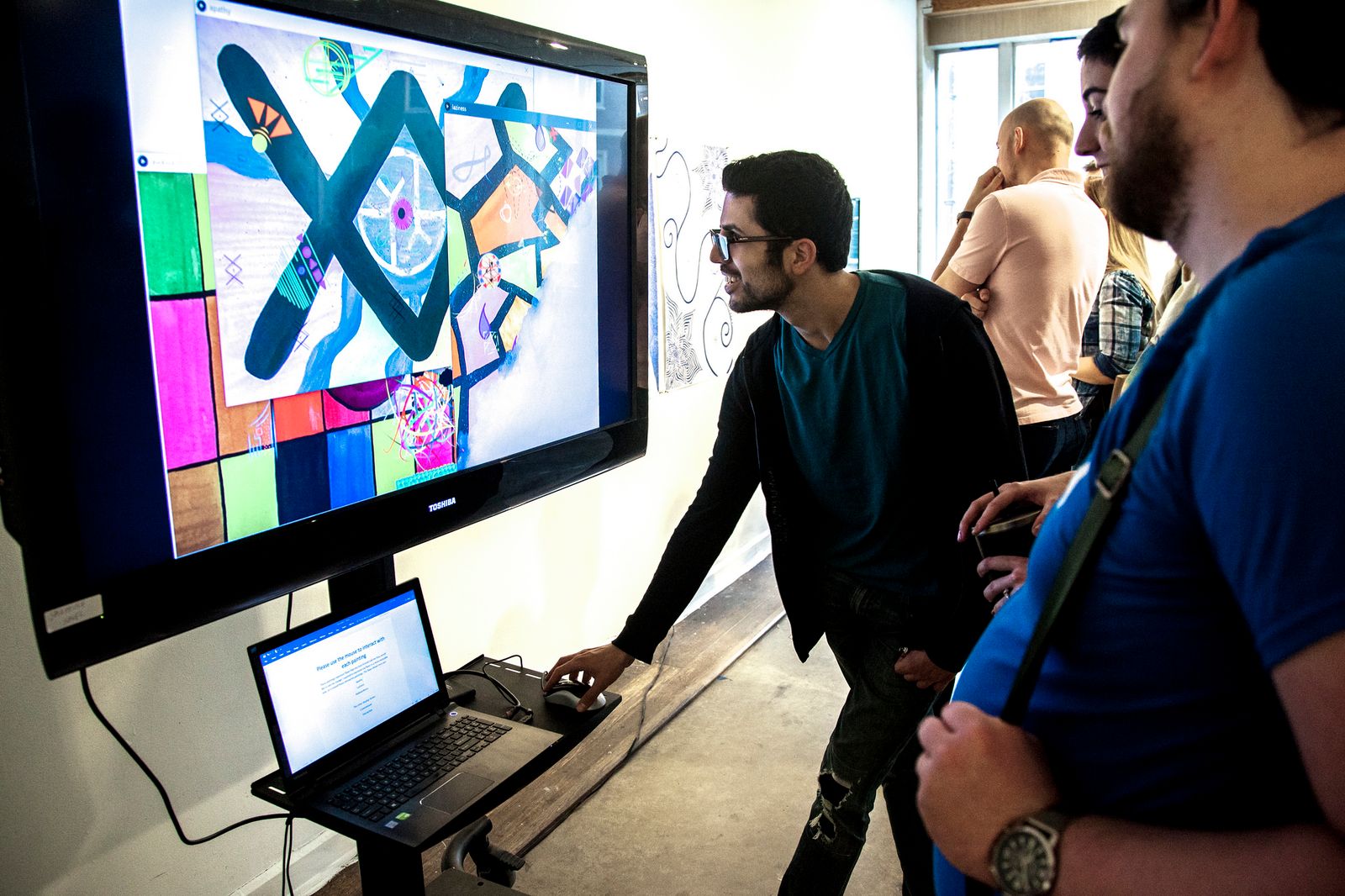 SMU students collaborate while looking at computer screen