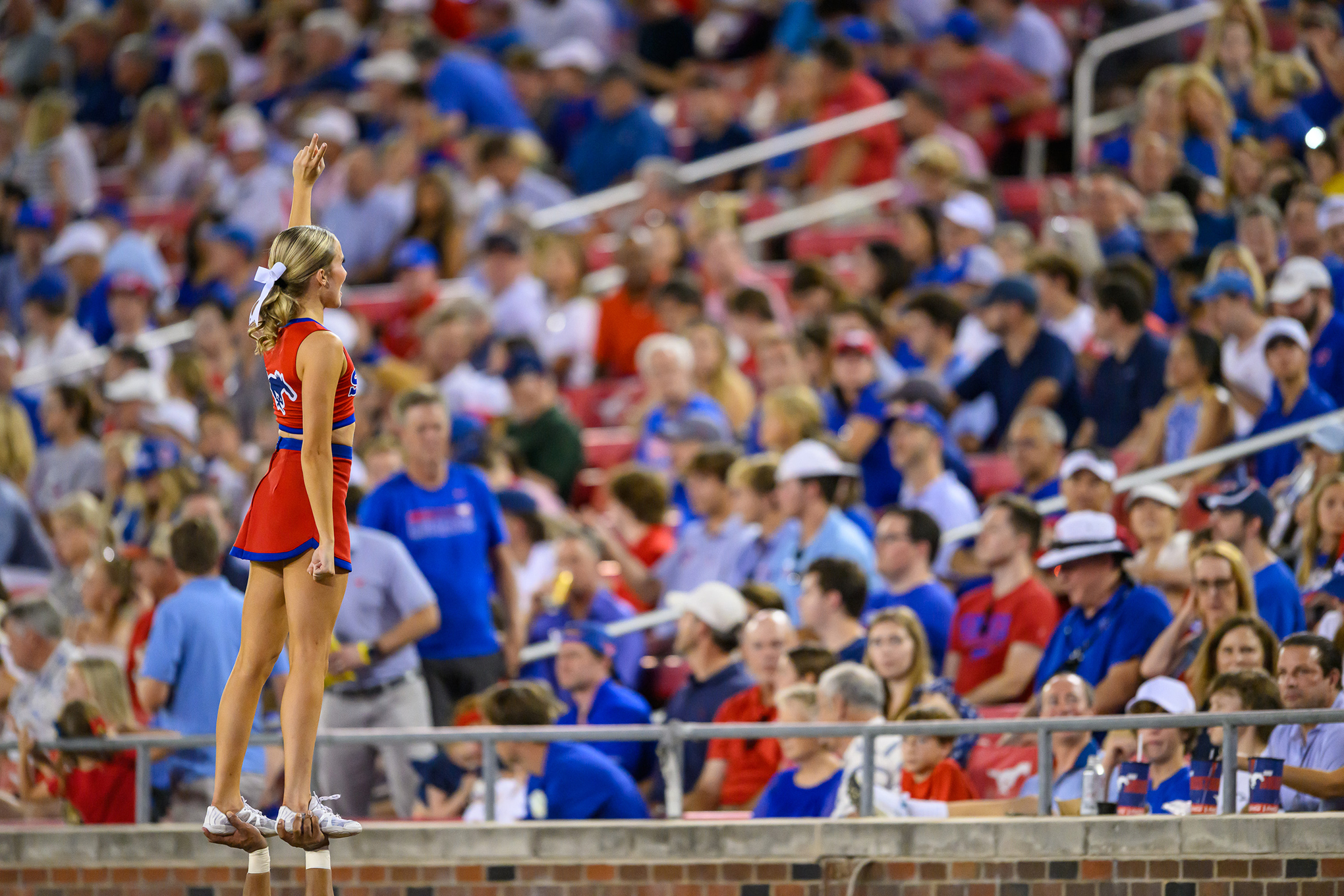 SMU cheerleader faces spectators during football game