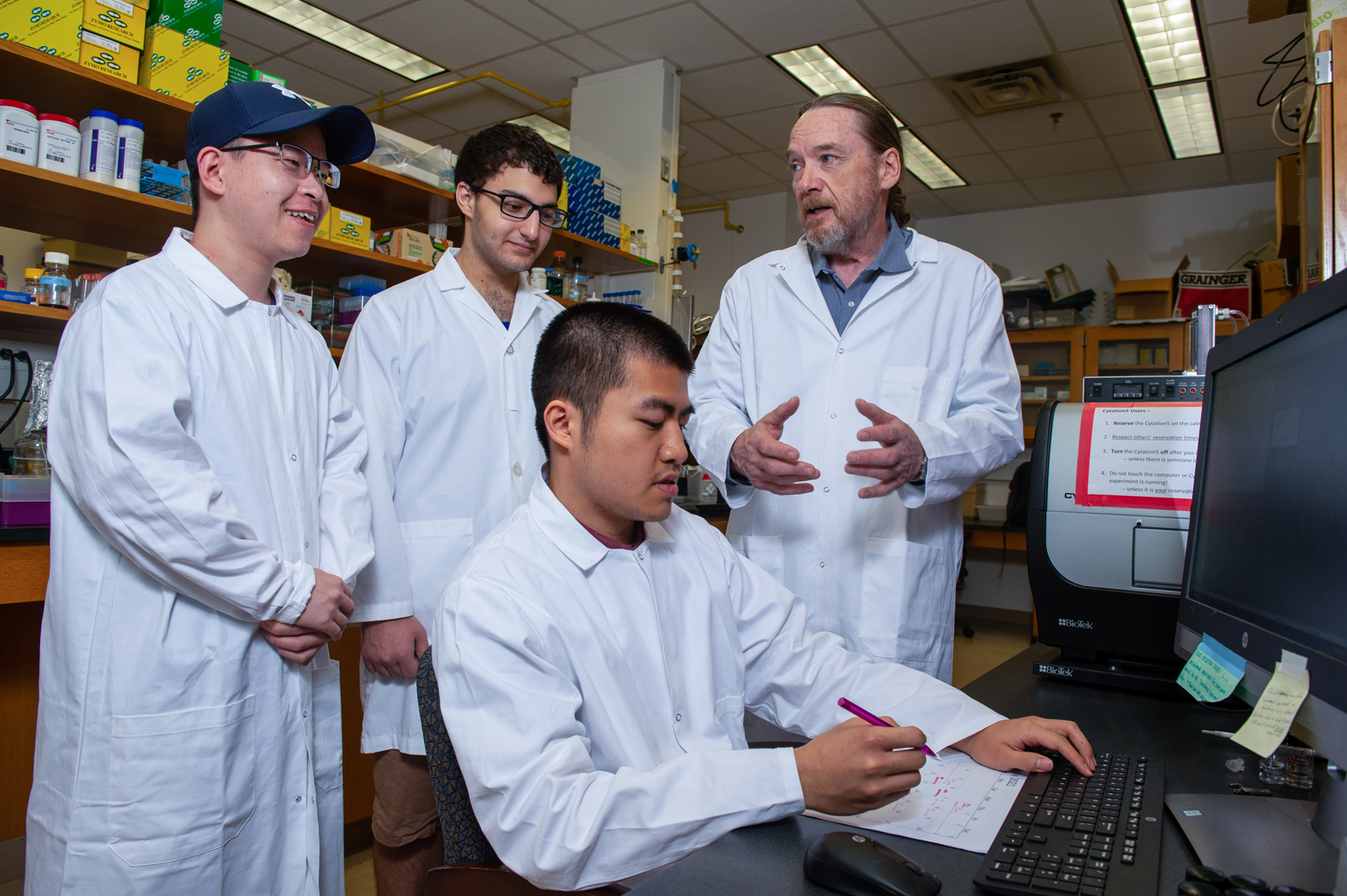 Image of professor and students in lab