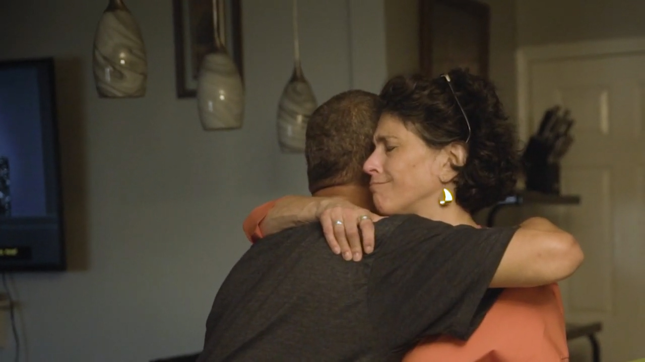 Director Pamela Metzger embracing a formerly incarcerated client, Troy Rhodes.