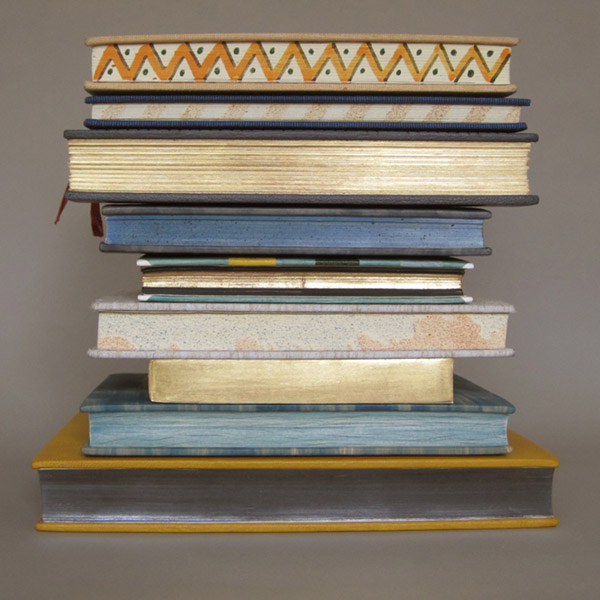 stack of books with gilded pages