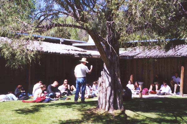 professor taking students on tour of taos campus building