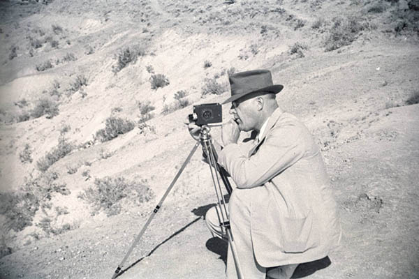 man with camera on tripod
