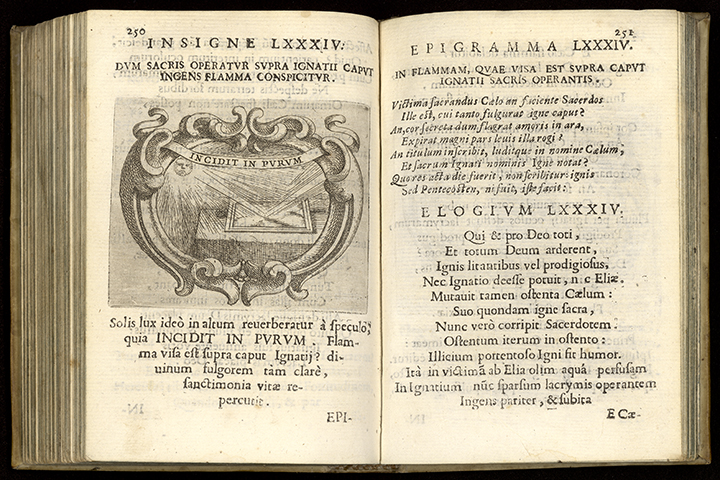 An open Latin book with an engraving of a mirror reflecting light from the sun on the left page. 