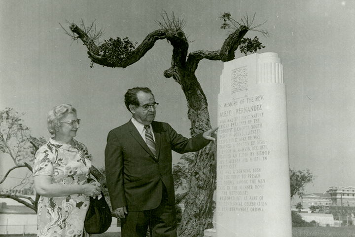Photograph of Clotilde and Alfredo Nanez at grave marker for Reverend Alejo Hernandez.