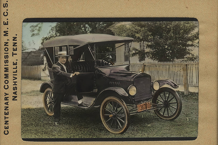 Lantern slide of a pastor posing with a Model T Ford.