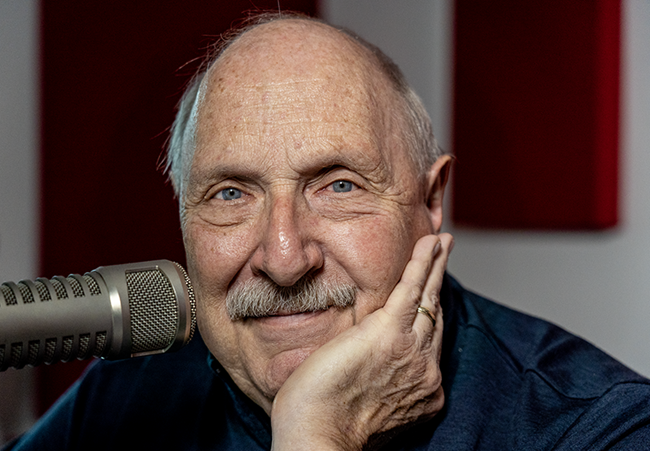 Close-up photo of Norm Hitzges next to a microphone