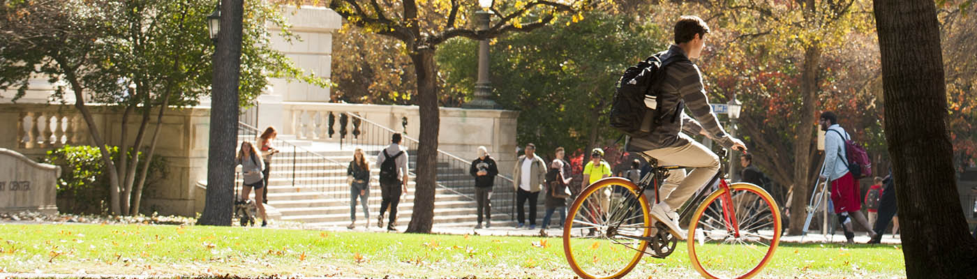 bicyclist crossing university lawn